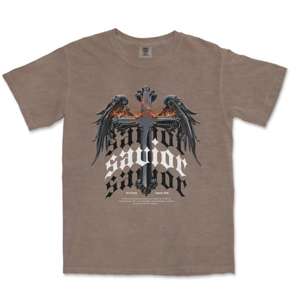 A taupe brown short-sleeve t-shirt featuring a gothic-style graphic of a double-headed eagle with wings on a cross, above the words 'SALVATOR SALVATOR', in black, white, and orange.