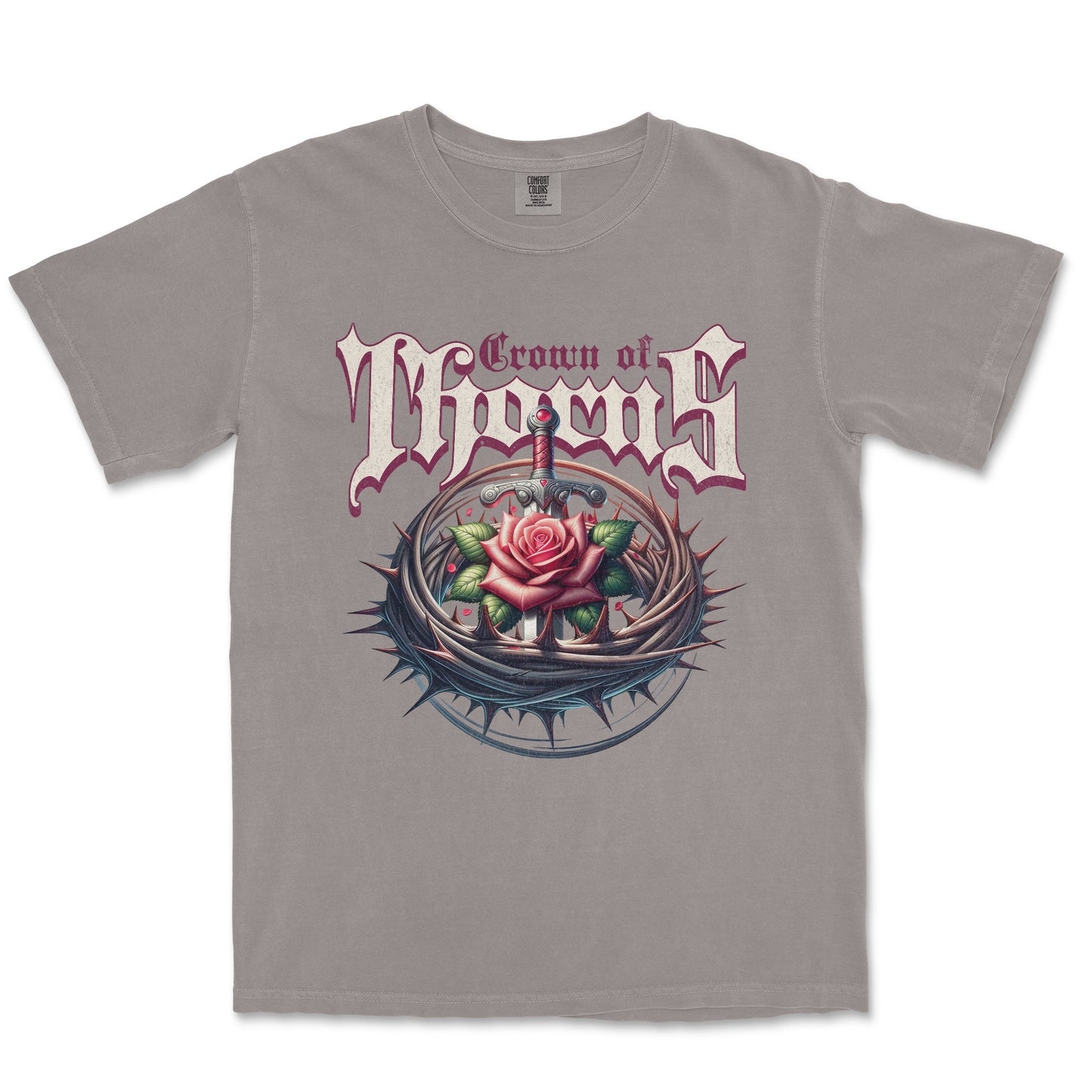 A gray short-sleeve crewneck t-shirt featuring a graphic print of the band Crown of Thorns. The design displays the band's name in a stylized gothic font above an illustration of a pink rose with thorns and a dagger.