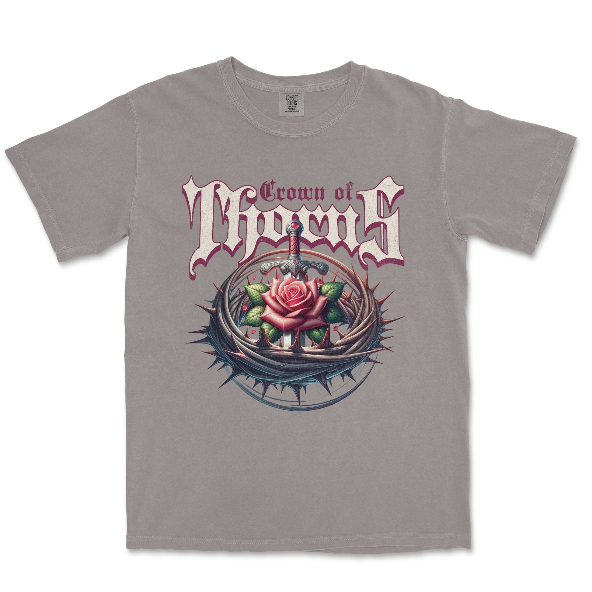 A gray short-sleeve crewneck t-shirt featuring a graphic print of the band Crown of Thorns. The design displays the band's name in a stylized gothic font above an illustration of a pink rose with thorns and a dagger.